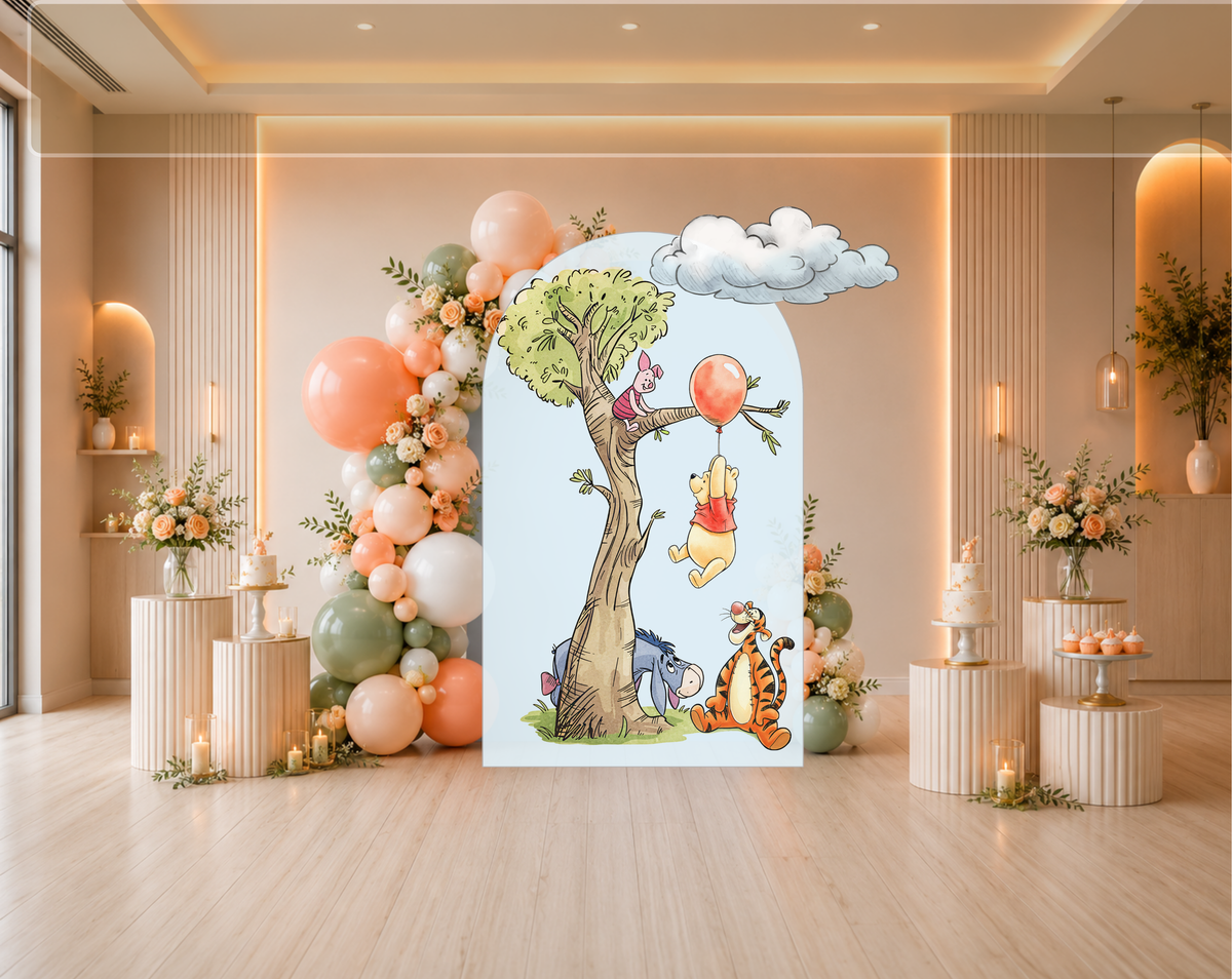Classic bear party backdrop with woodland tree, pastel arch panels and colorful character cutouts for a sweet baby celebration.
