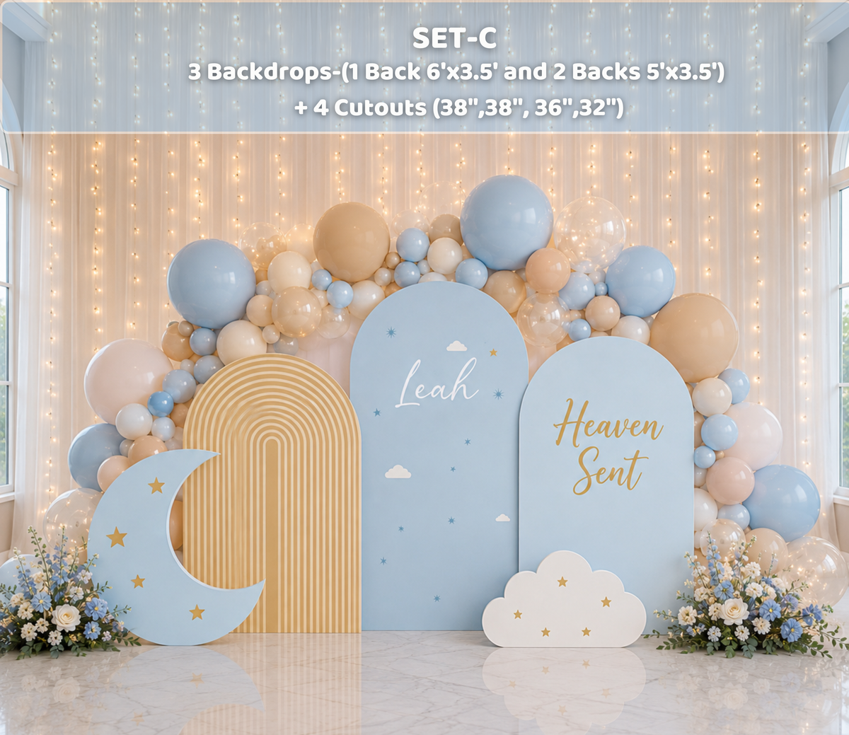 Light blue celestial baby shower backdrop with crescent moon cutout, cloud accents and soft beige blue balloon garland.