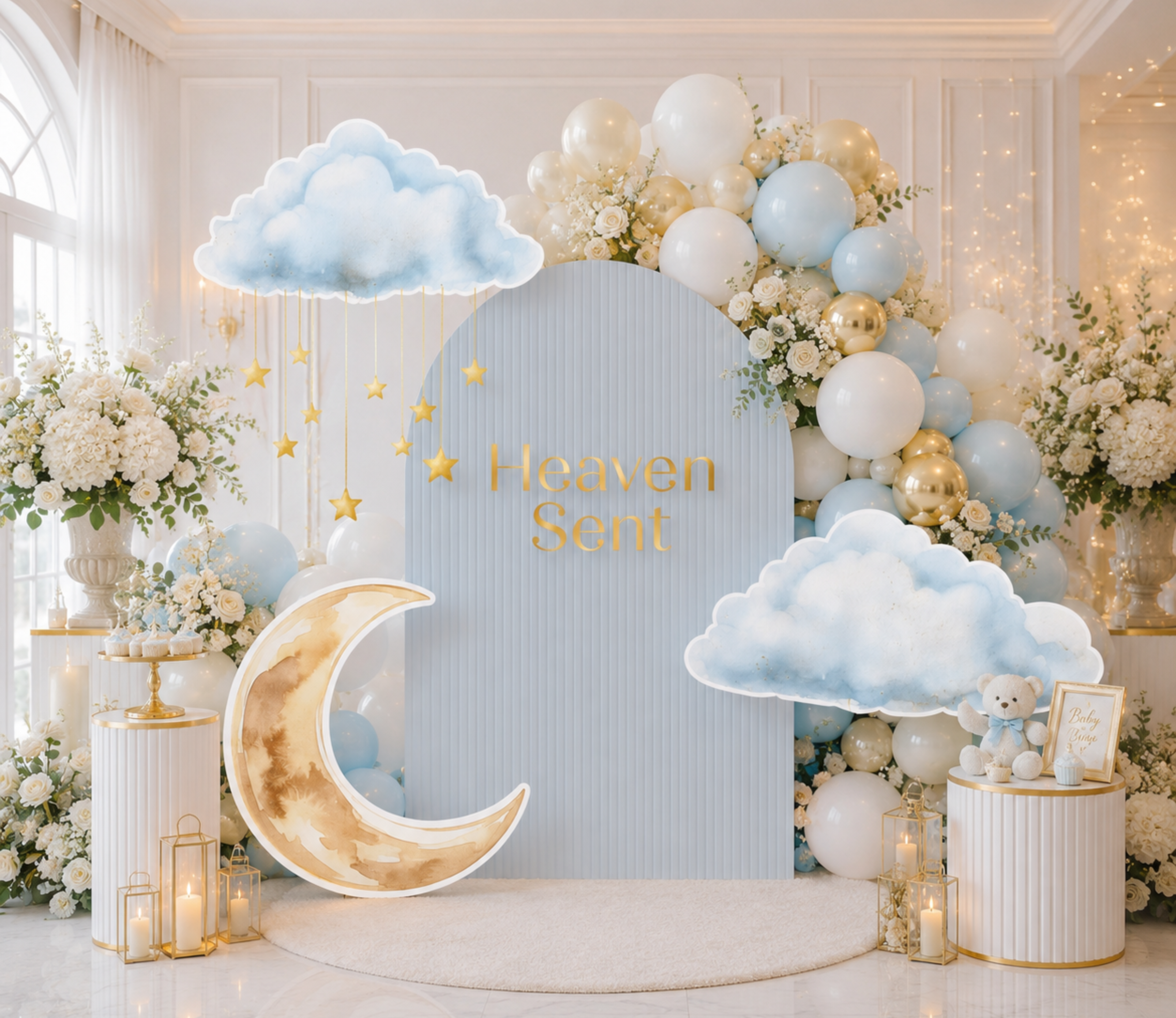 Heaven Sent baby shower setup with pale blue and ivory backdrop panels, moon cutouts and elegant neutral party decorations.