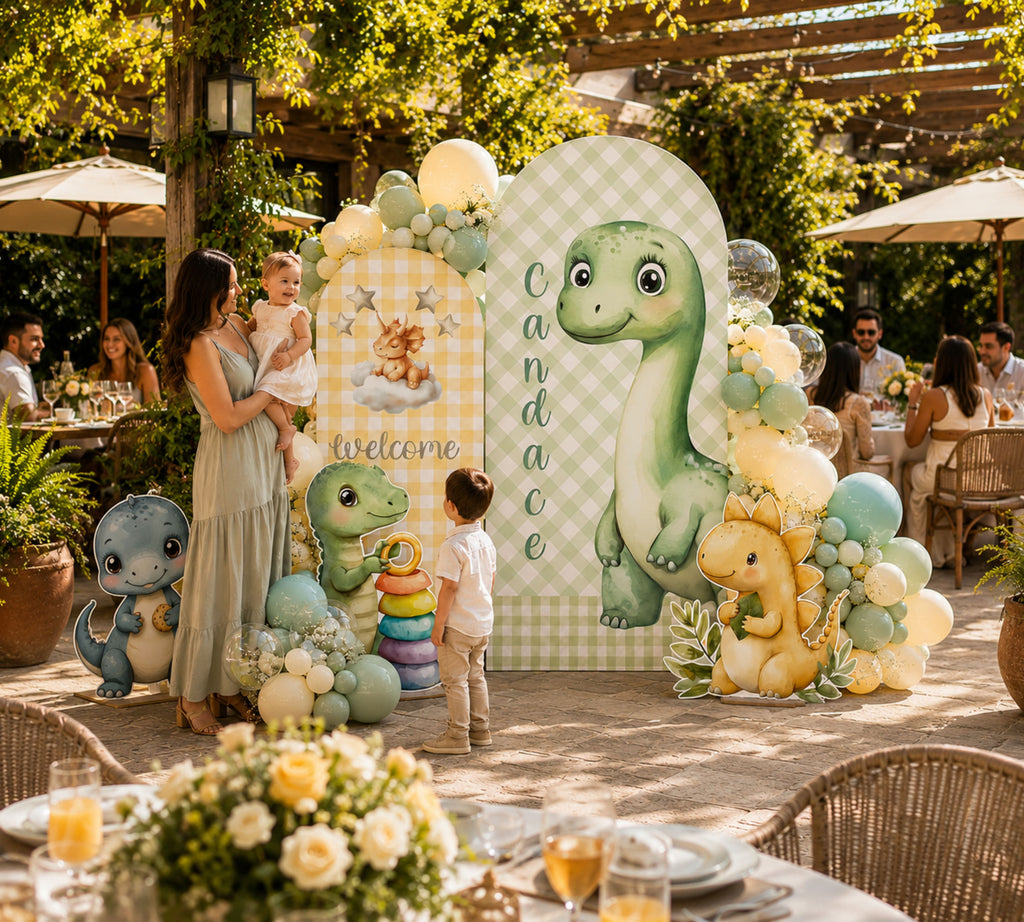 Outdoor dinosaur party setup with green dino cutout, balloon garland and earthy baby dinosaur decor for a custom celebration.