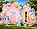 Personalized puppy family first birthday backdrop with pink doghouse arch, pastel balloon garland, character cutouts and number two party decoration.