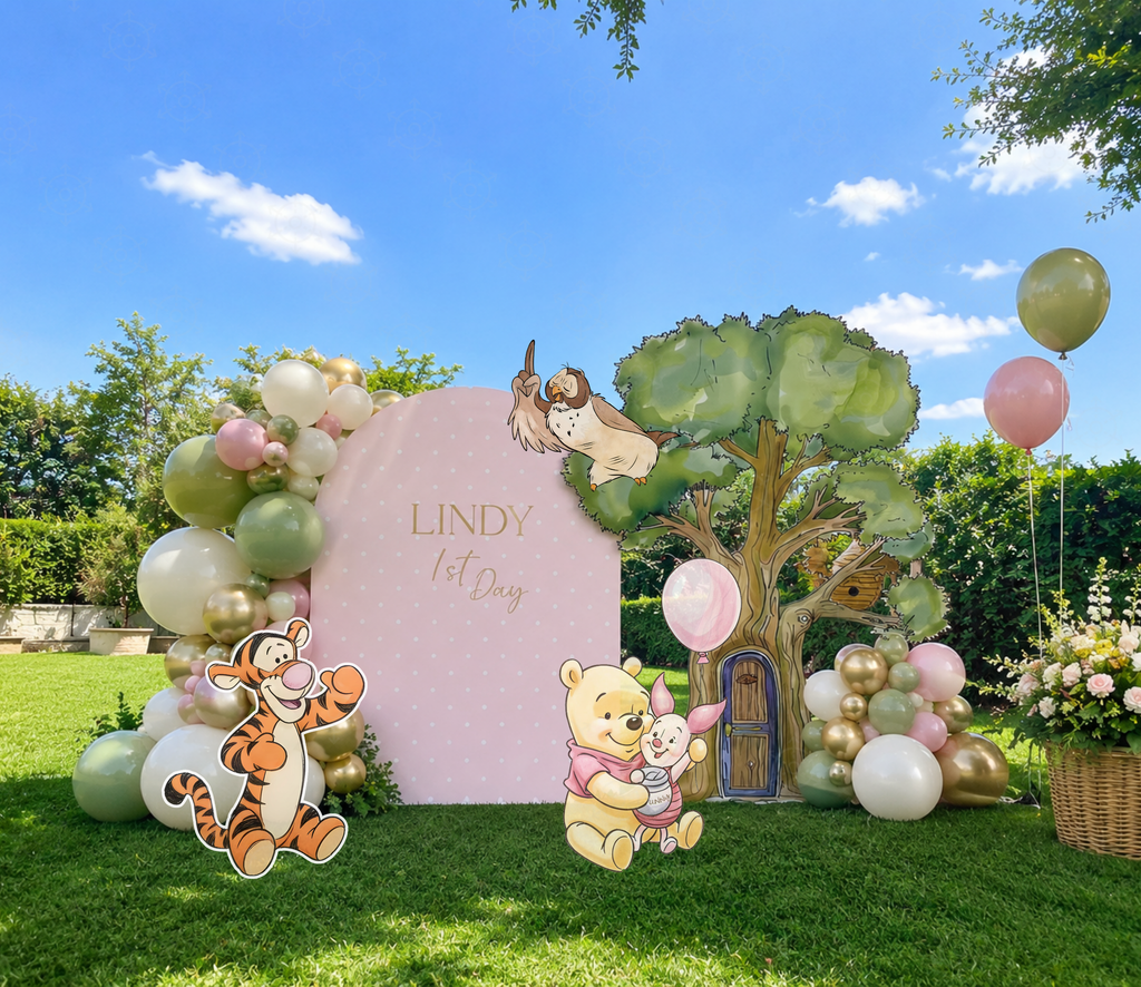 Honey Bear storybook backdrop and cutouts displayed outdoors with pastel balloons and whimsical party decorations.
