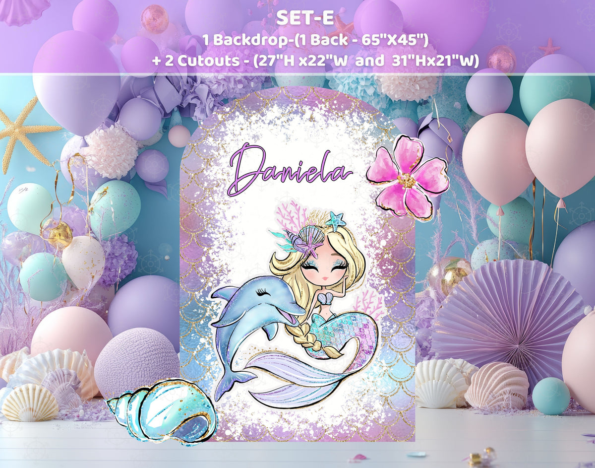 Mermaid birthday photo backdrop with pink blue and purple balloons, ocean details and personalized party signage.