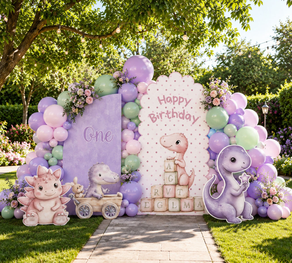Lavender baby dinosaur party backdrop with pastel balloon arch, personalized panel and cute dino cutouts for a whimsical celebration.
