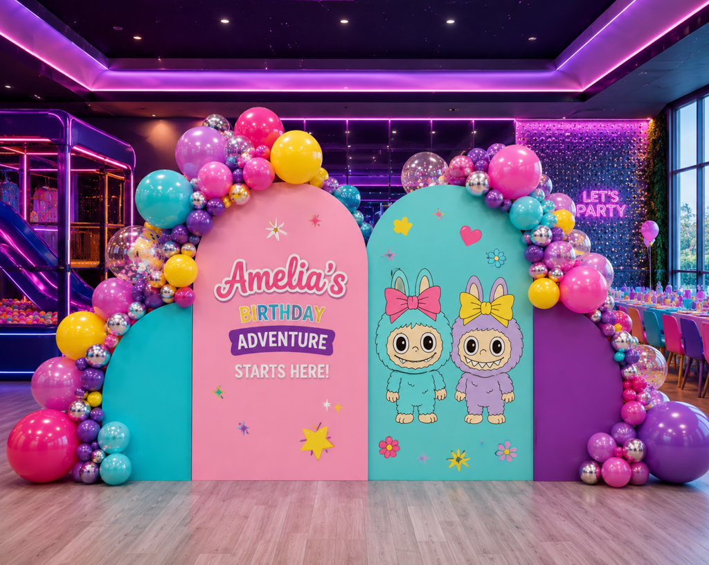 Cute monster birthday backdrop with colorful balloons, pastel arch panels and kawaii party decorations in a neon-style indoor setup.