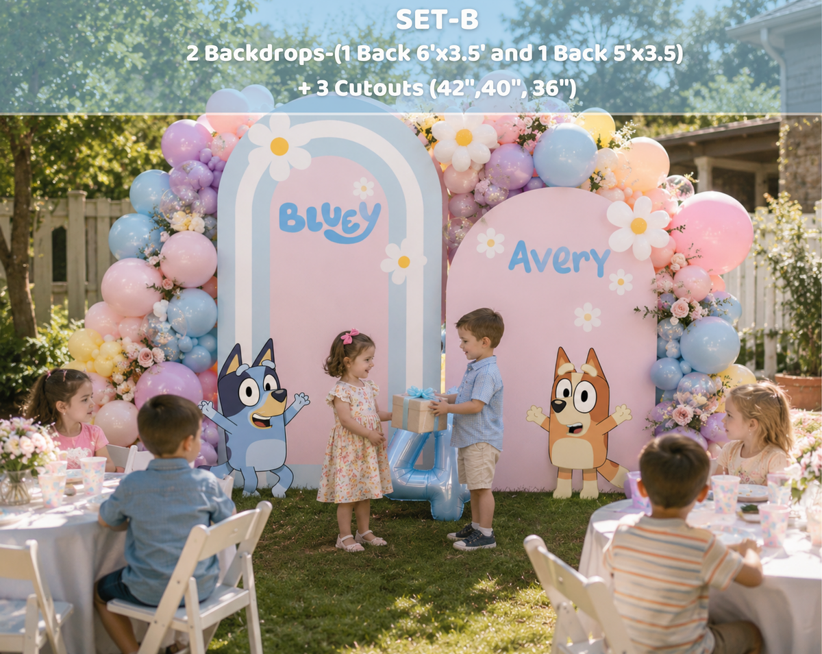 Outdoor puppy family party backdrop with pink and blue panels, pastel balloons and personalized birthday character decorations.