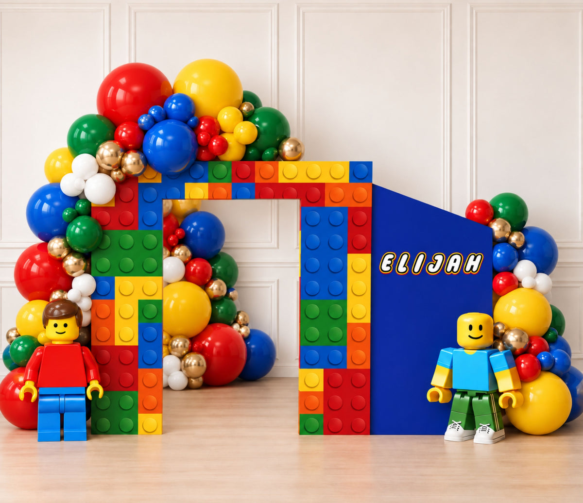 Personalized building block birthday setup with integrated shelves, bright balloon garland and colorful brick inspired party decor.