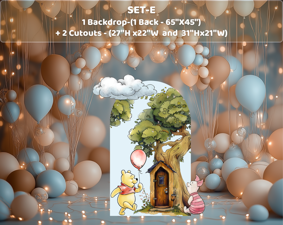 Classic bear baby shower backdrop with blue arch panel, woodland tree and whimsical character decorations in a bright indoor venue.