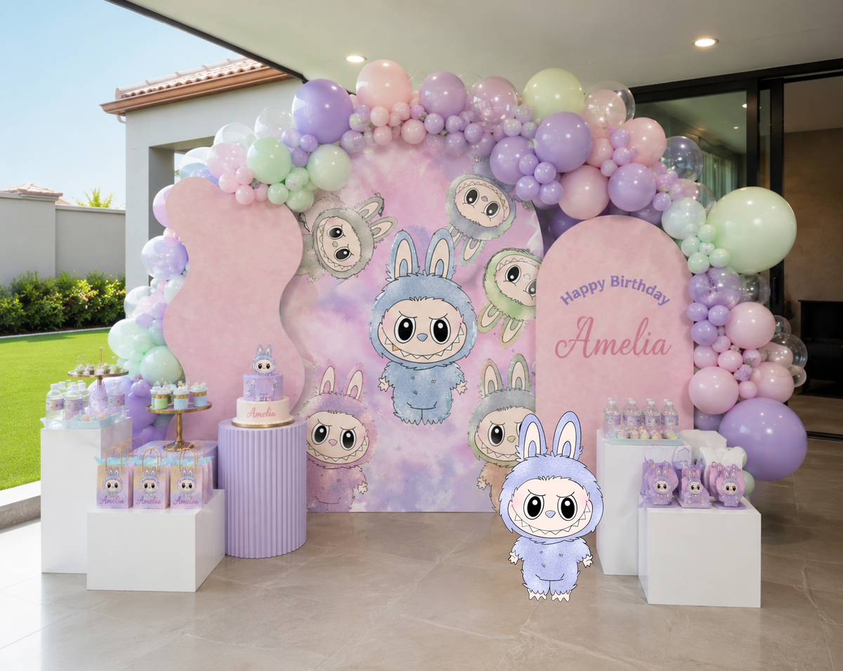 Personalized cute monster birthday setup with layered pastel backdrops, balloon garland and matching character cutouts for an indoor party.