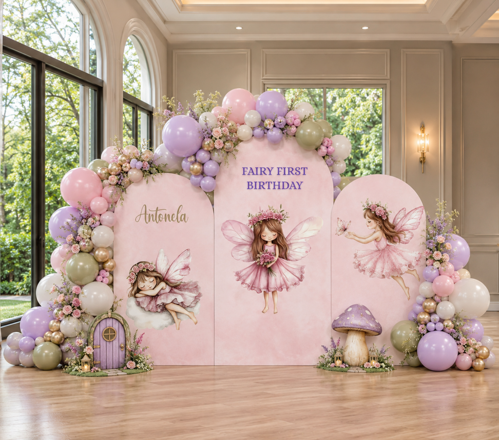 Personalized pink fairy birthday backdrop with pastel balloon garland, enchanted forest details and fairy cutouts for a magical first birthday celebration.