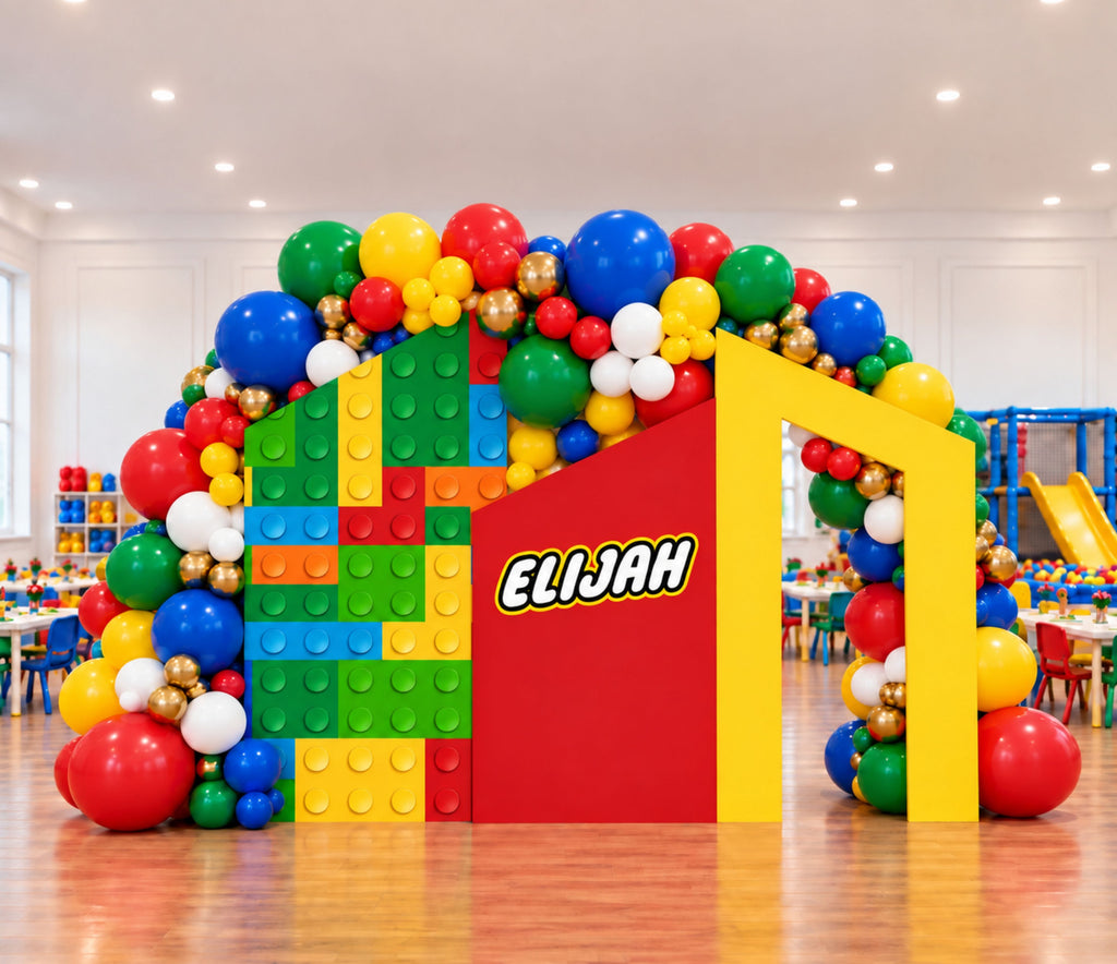 Colorful building block party backdrop with shelf display, personalized details and bright primary color birthday decorations.