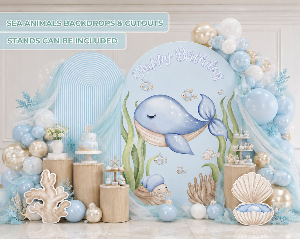 Cute ocean animals birthday backdrop with blue whale illustration, pastel balloon garland, seashell accents and under the sea party decorations.
