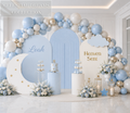 Personalized Heaven Sent baby shower backdrop with light blue arches, moon and cloud cutouts, white blue balloons and celestial baby boy decorations.
