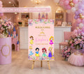 Personalized princess birthday welcome sign displayed on an easel with pastel floral decor, soft balloons and elegant fairytale party styling.