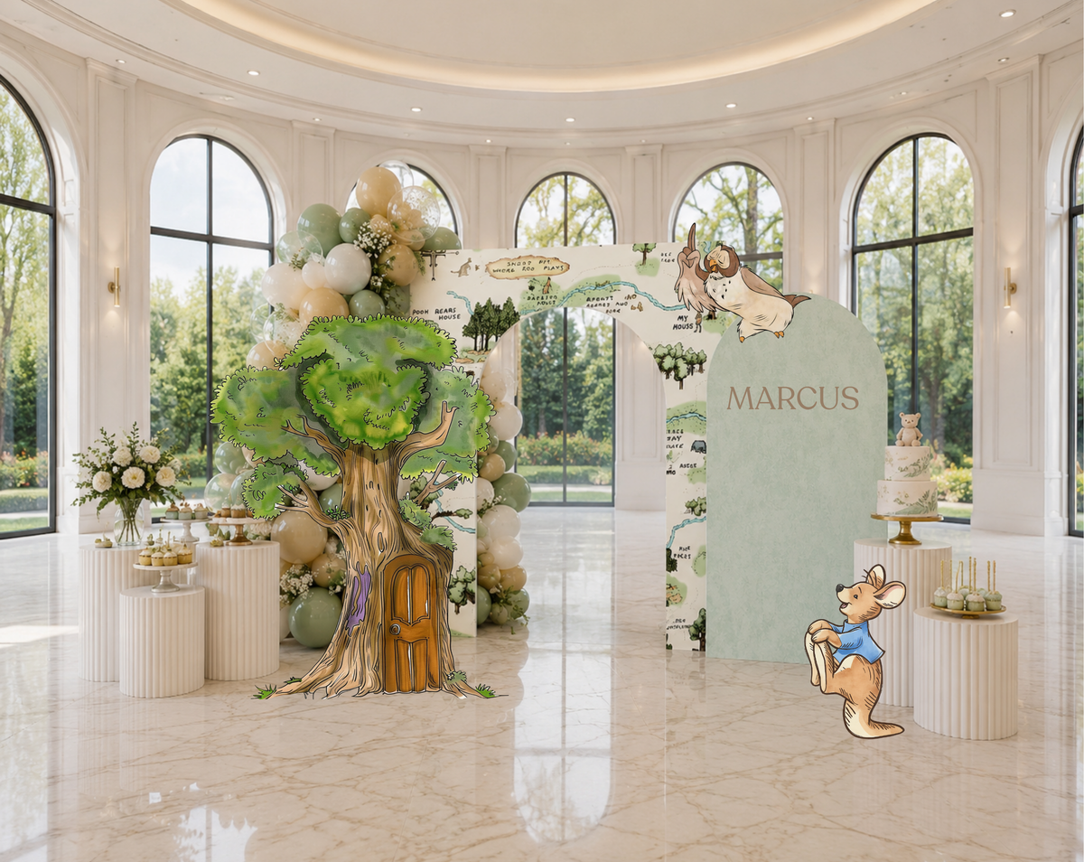 Elegant woodland baby shower backdrop with sage green arch panels, floral details and classic bear inspired character decorations.