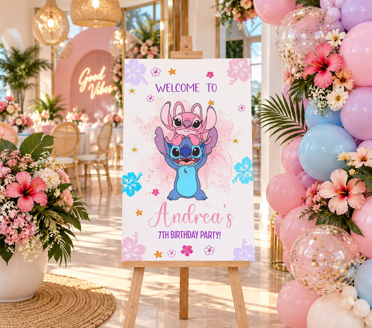 Tropical blue alien birthday welcome sign with custom name, floral accents and colorful Hawaiian themed party decorations.