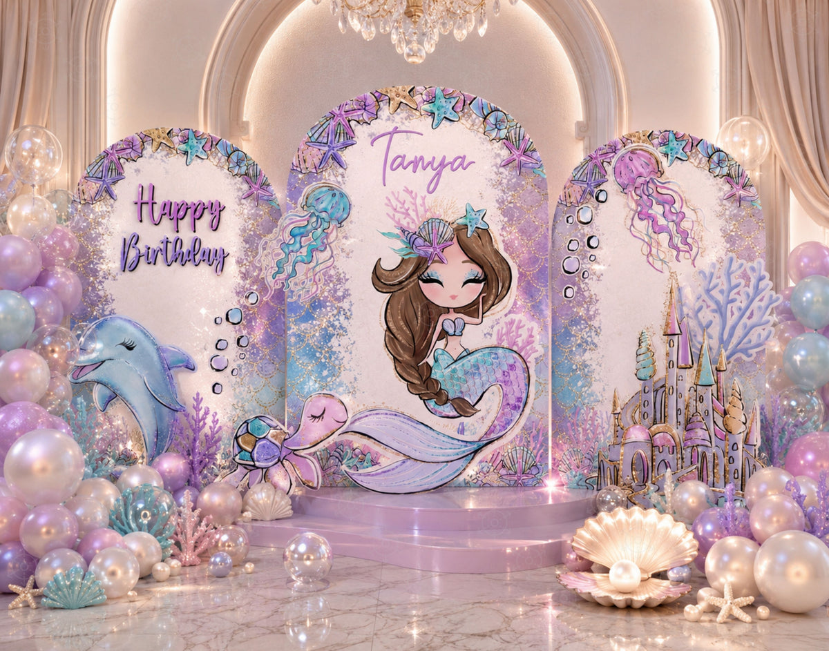 Personalized mermaid birthday setup with lavender arch panels, seashell details, pastel balloons and elegant under the sea decor.