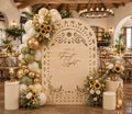 Natural wood papel picado wedding backdrop with personalized design and florals for rustic Mexican wedding decor