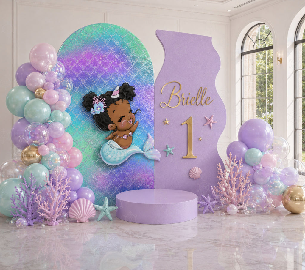 Little mermaid first birthday backdrop with pastel green personalized panel and ocean themed decorations