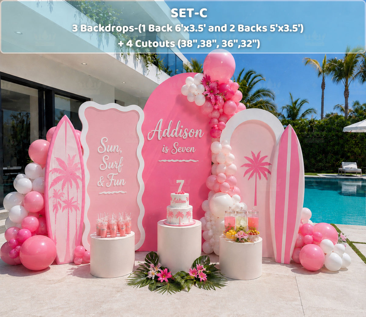 Pink tropical birthday party backdrop and coordinating cutouts styled beside a swimming pool
