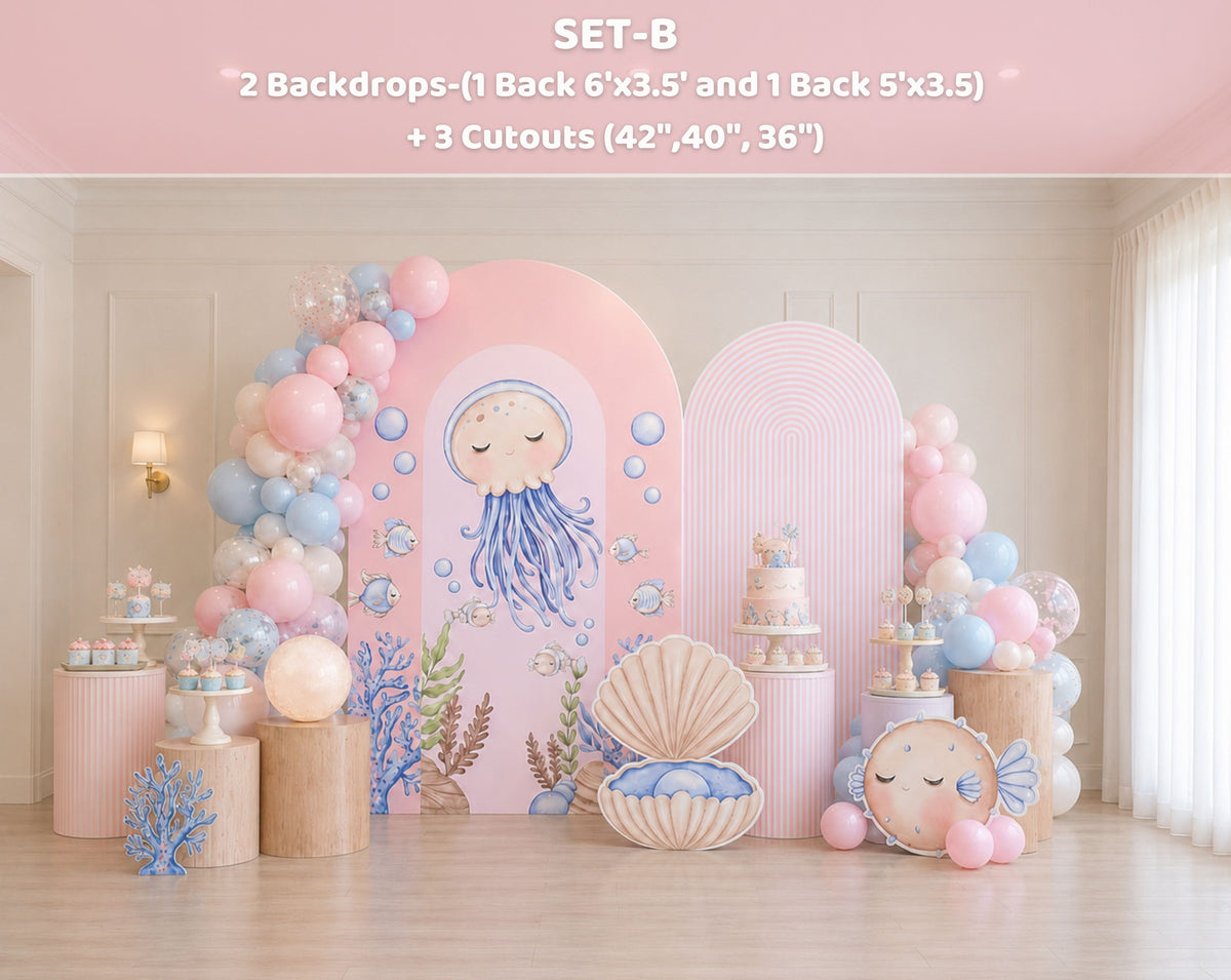 Cute ocean animals party backdrop with pastel pink arch panels, balloon garland and sea themed decorations for a girls birthday party.