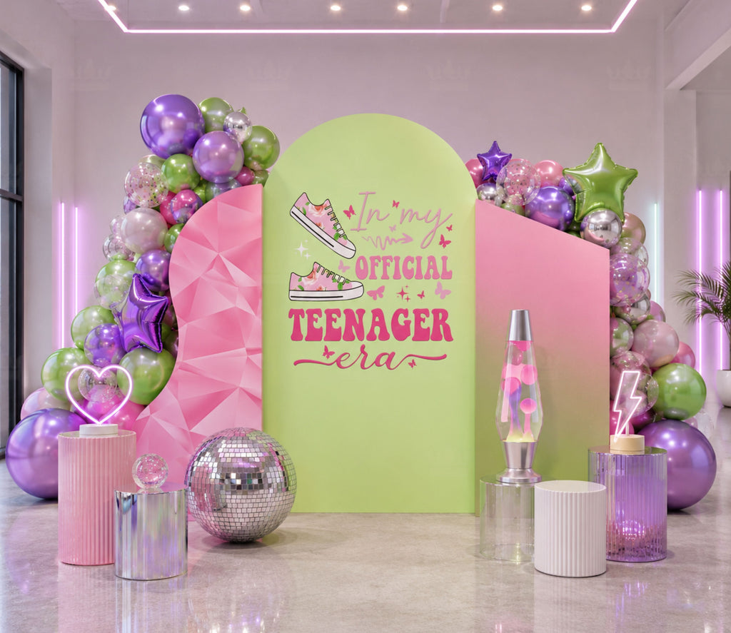 Green and purple teen girl birthday backdrop with balloon clusters, trendy graphics and personalized photo booth party decorations.