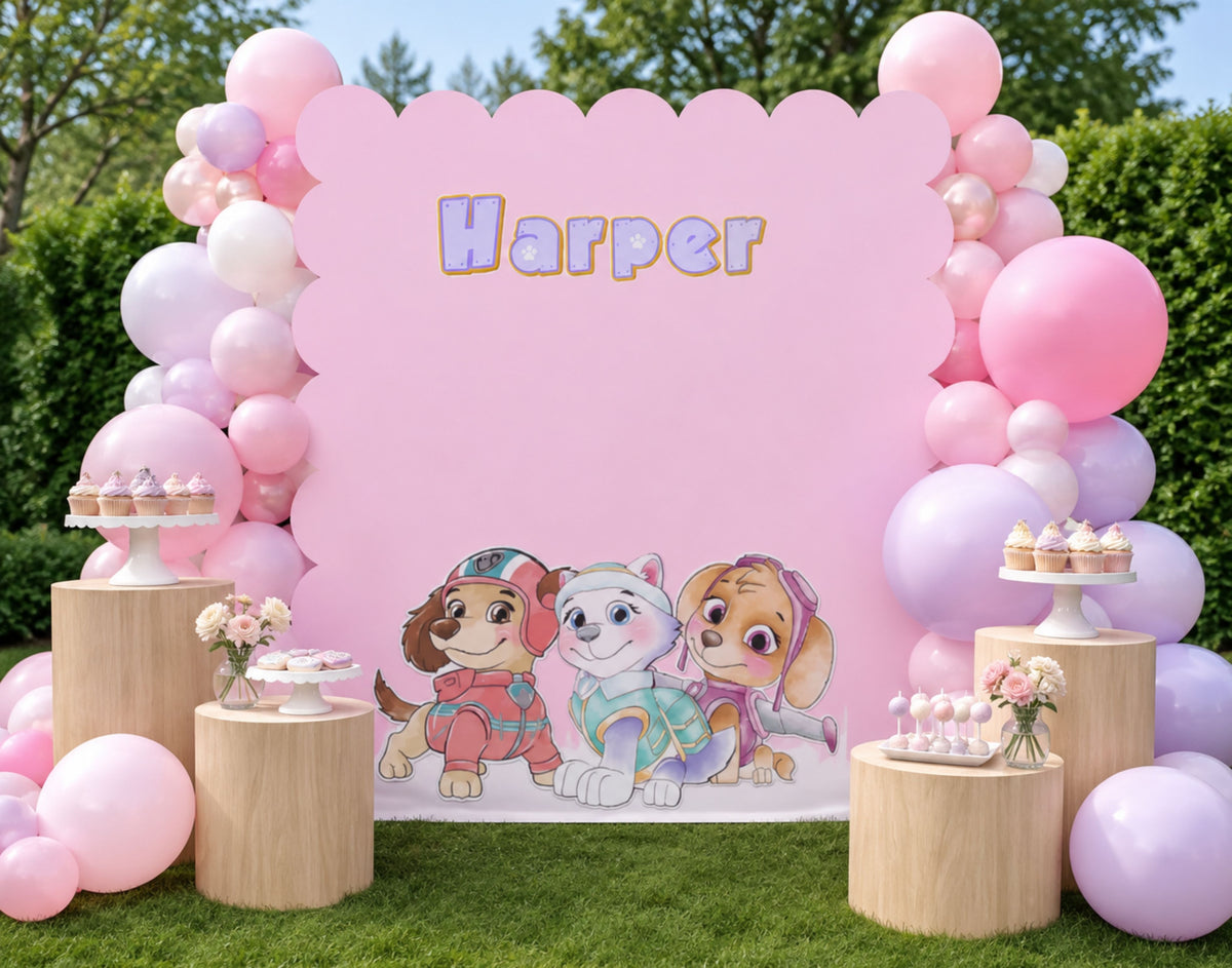 Personalized pink puppy birthday backdrop with name sign, balloon garland and themed party styling for a custom event display.
