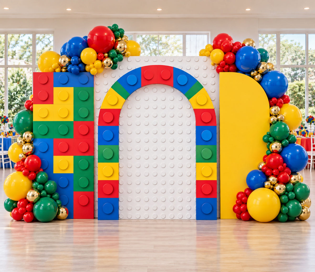 Building block birthday backdrop with multicolor arch design, bold balloons and playful kids party decorations.