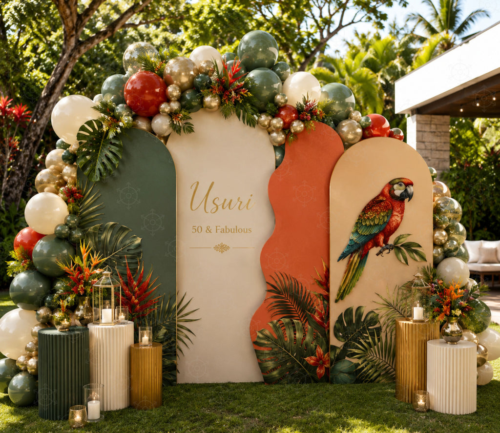 Green tropical parrot birthday backdrop with orange accents, lush flowers and personalized party decor