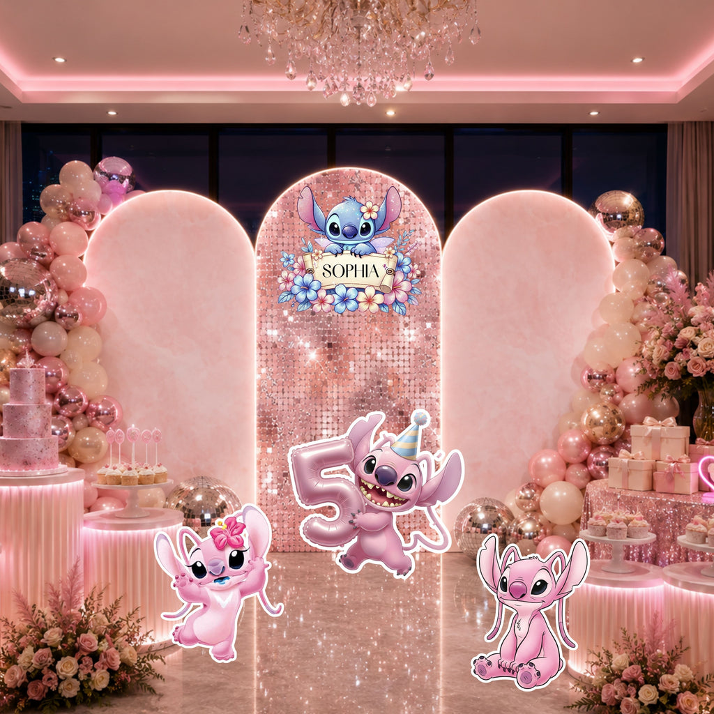 Pink tropical birthday backdrop with rounded panels, soft floral decor, personalized blue alien design and coordinating party cutouts.