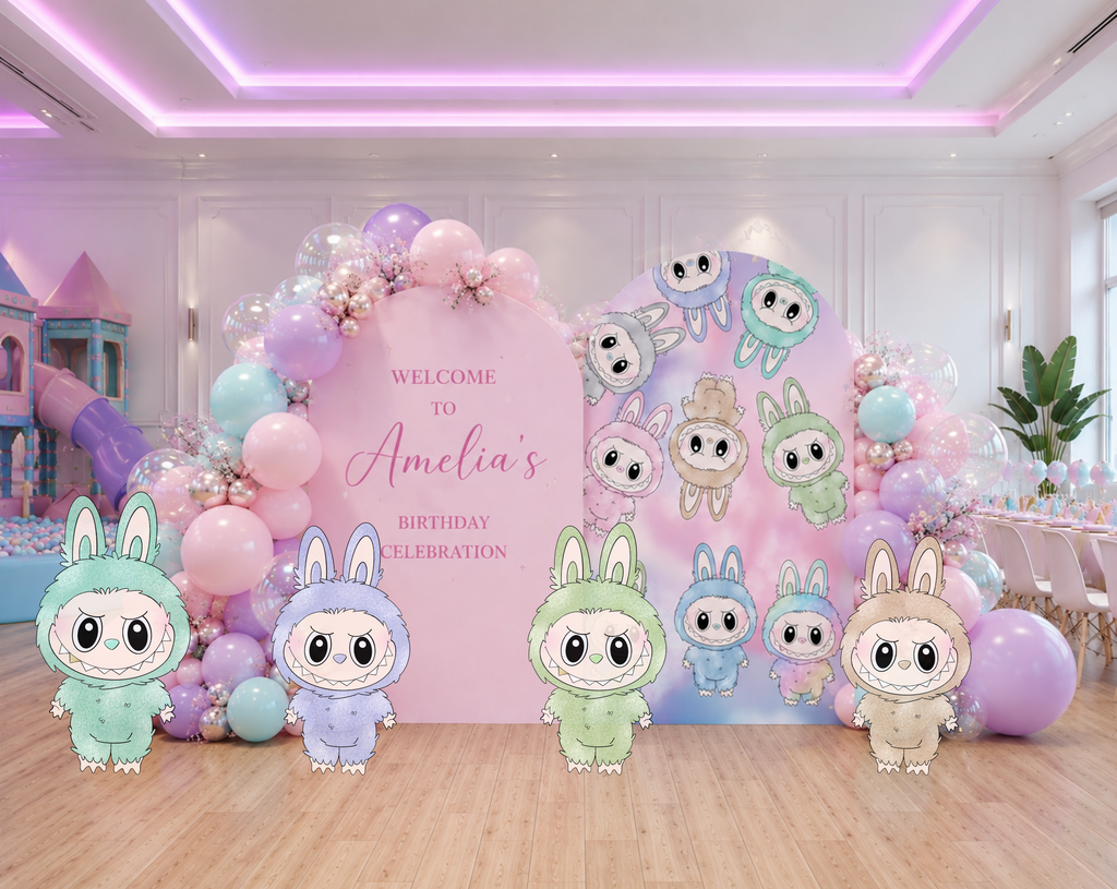 Pastel cute monster birthday backdrop with personalized name panel, kawaii character cutouts and balloon decor for a photo-ready party display.