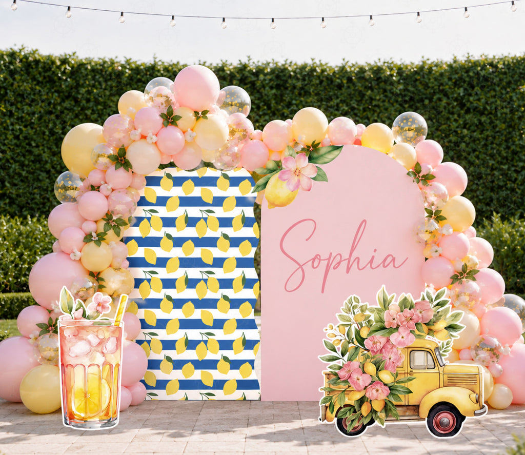 Pink lemon party backdrop with floral arch and personalized celebration decor
