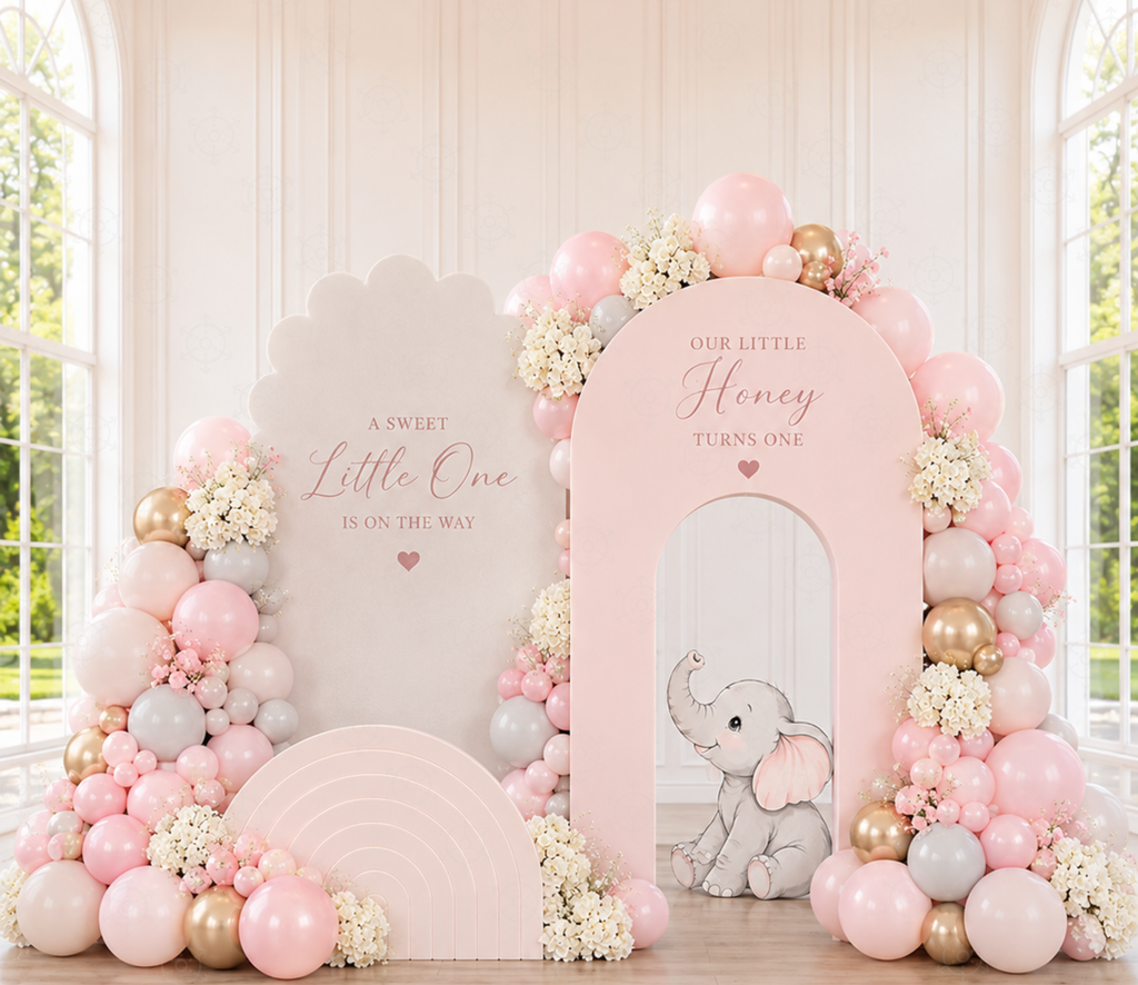 Personalized baby elephant party backdrop with soft pink balloons and florals for a christening or first birthday