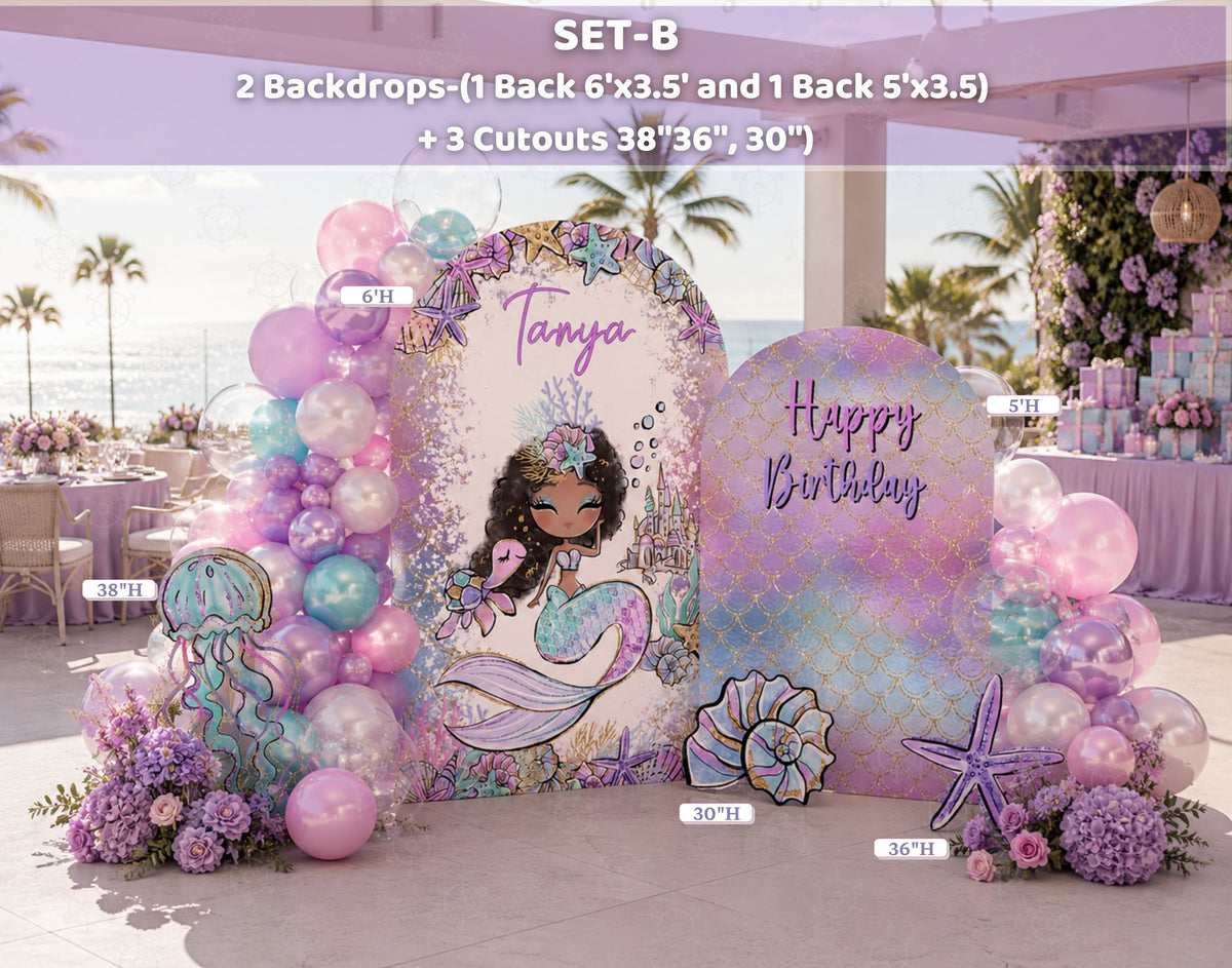 Indoor mermaid birthday backdrop with soft pink and lavender balloons, layered arch panels and matching ocean themed cutouts.