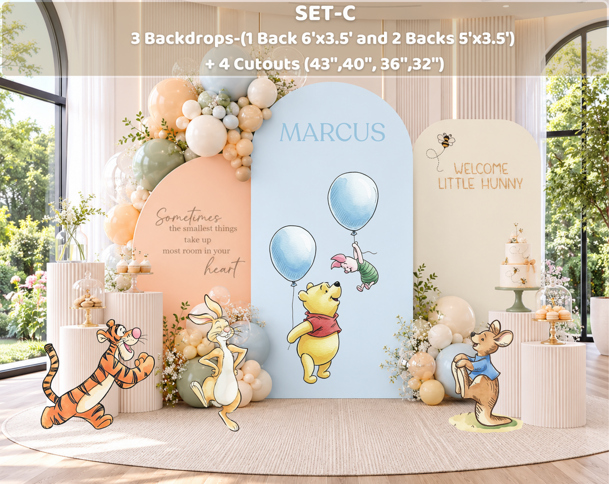 Personalized woodland baby shower setup with peach backdrop panels, classic bear inspired cutouts and soft botanical decorations.