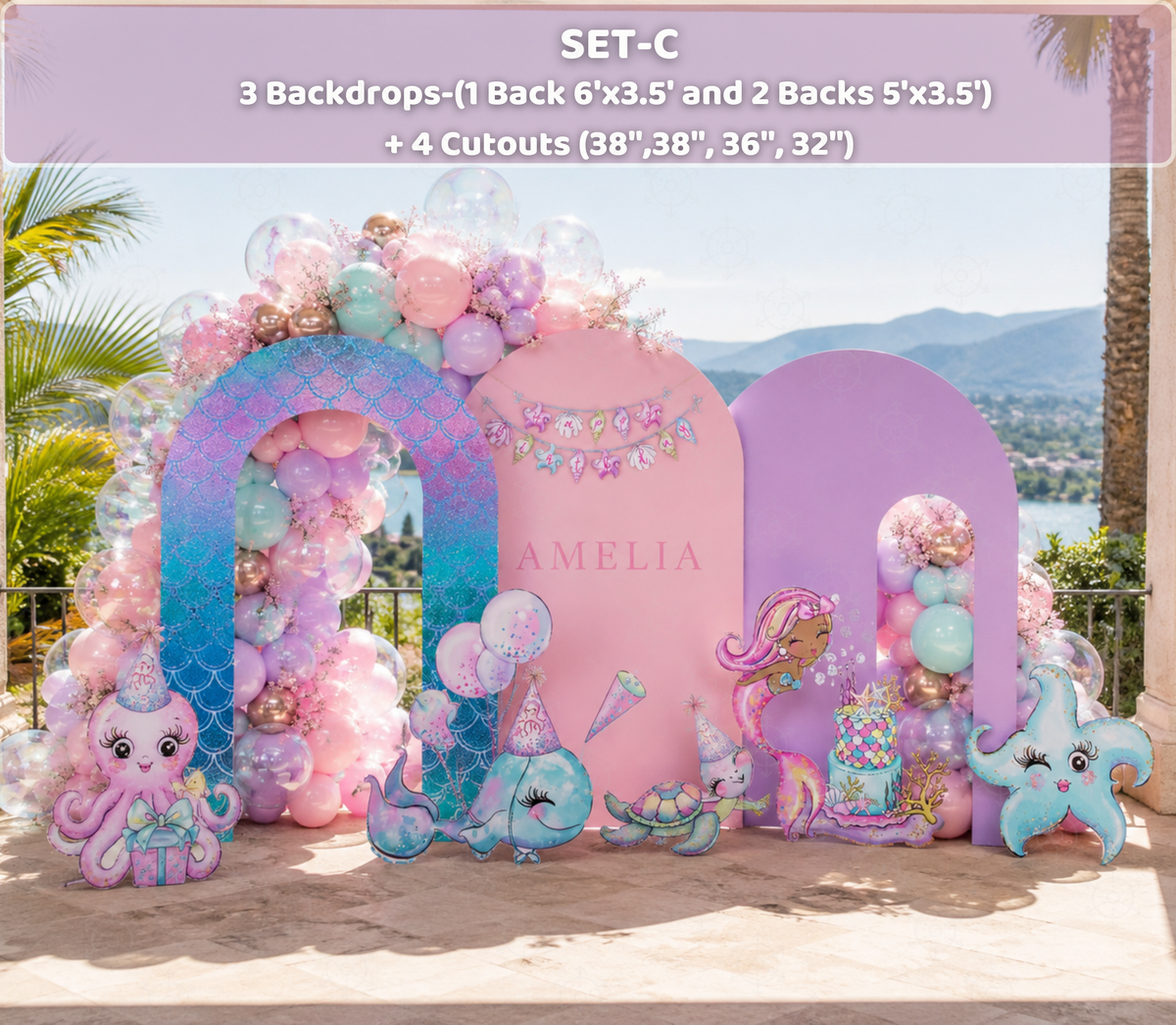 Pink and purple under the sea birthday backdrop with mermaid cutouts, pastel balloons and personalized party decor.