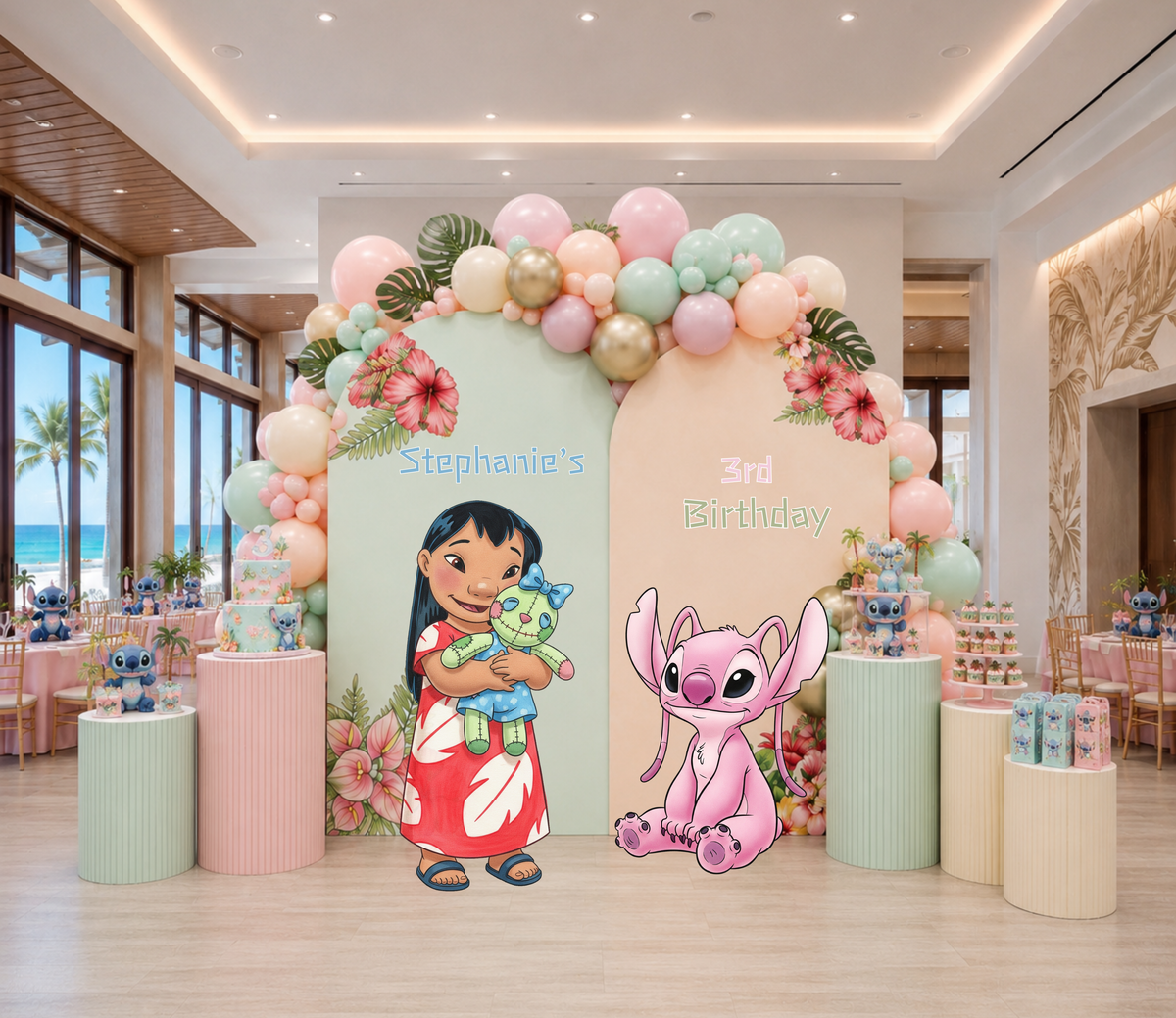 Indoor Hawaiian birthday party setup with pastel arch backdrop, tropical flowers, balloons and colorful character cutouts.