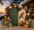Tropical parrot birthday backdrop with personalized green arch panels, floral balloons and sunset party decor