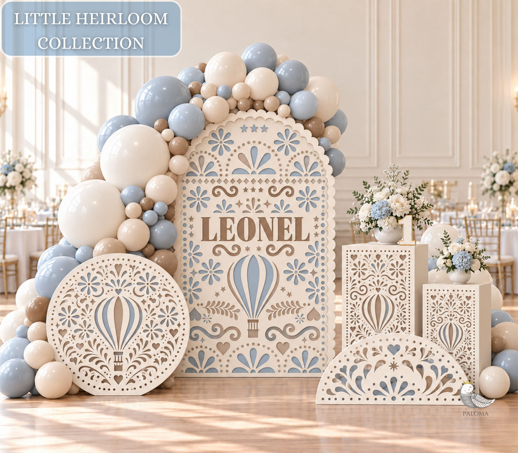 Blue and ivory papel picado baptism backdrop set with balloons, circular decor, half circle, and matching pedestal for a baby boy celebration.