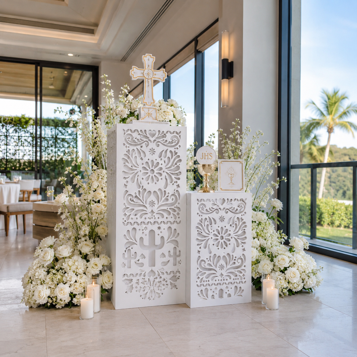 White Papel Picado backdrop with matching pedestals in a bright modern event space