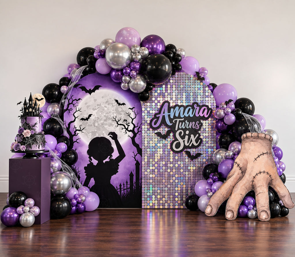 Black and purple gothic birthday backdrop with spiderweb details, dark balloon decor and personalized character cutouts.