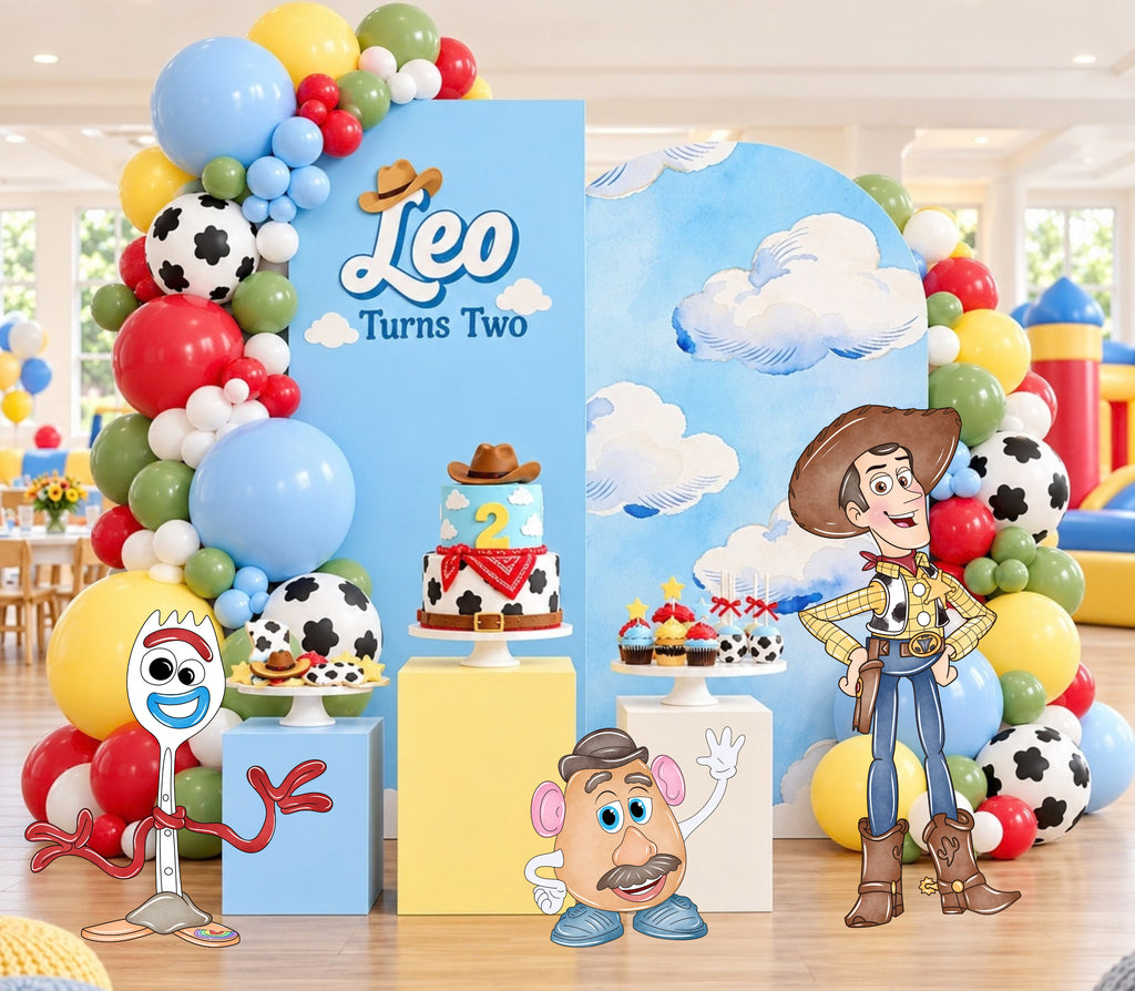 Pastel western birthday backdrop with soft blue pink and yellow panels, toy character cutouts and personalized kids party decor.