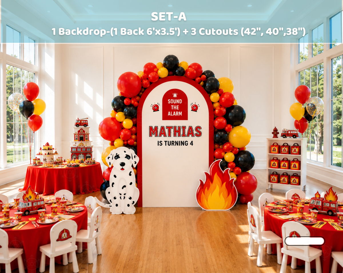 Fire station birthday setup with a white arch panel, red firehouse cutout, balloon arch and firefighter-themed dessert tables indoors.