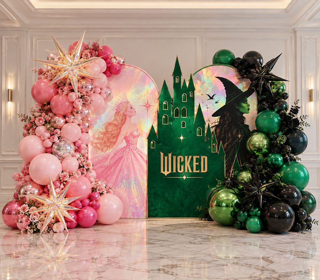 Pink and green fantasy birthday backdrop with dramatic balloon garlands, castle-inspired artwork and personalized party styling.