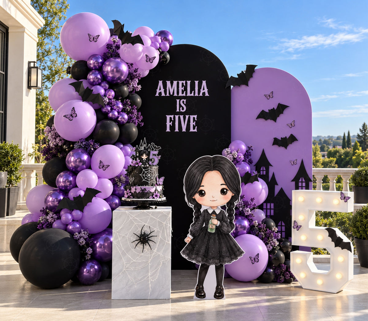 Outdoor gothic birthday backdrop with purple and black arch panels, balloons and personalized dark character party decorations.