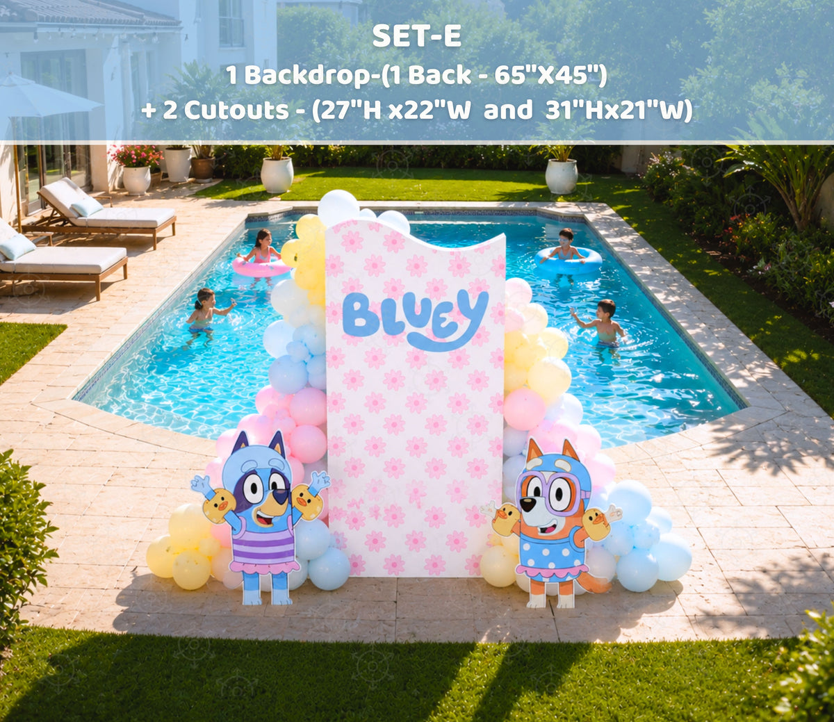 Pastel blue pool party backdrop reflected in a swimming pool with blue puppy birthday decorations and summer party styling.
