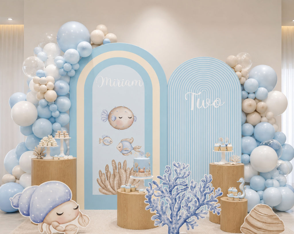 Blue under the sea birthday backdrop with rounded arch panels, balloon clusters and ocean themed cutouts for a personalized kids celebration.