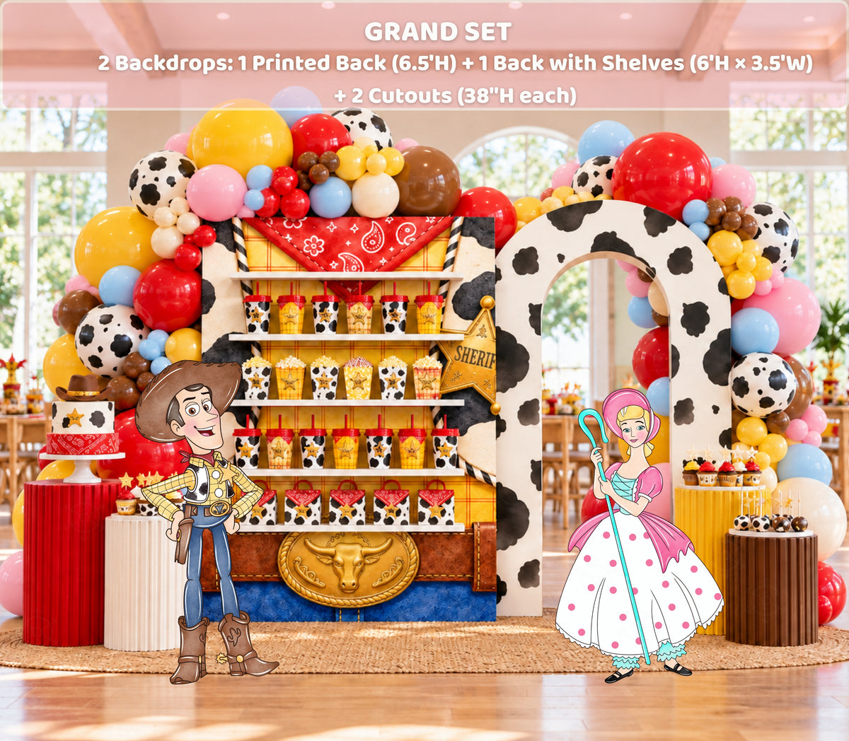 Western birthday backdrop with integrated shelf display, bright balloon garland and colorful toy-themed party decorations.