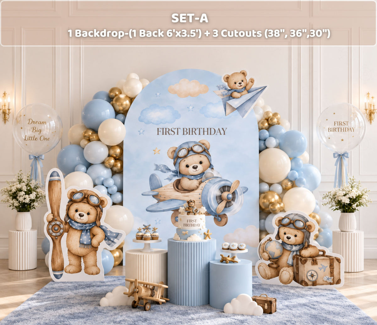 Aviator bear first birthday backdrop with soft blue arch panels, hot air balloon details, neutral balloon garland and matching bear cutouts