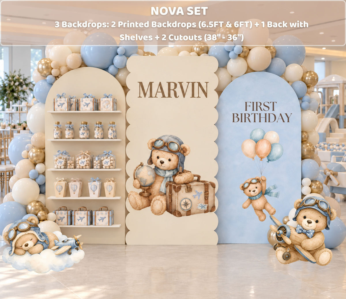 First birthday aviator bear backdrop with integrated shelves, soft blue and beige tones, balloon decor and matching bear party details.